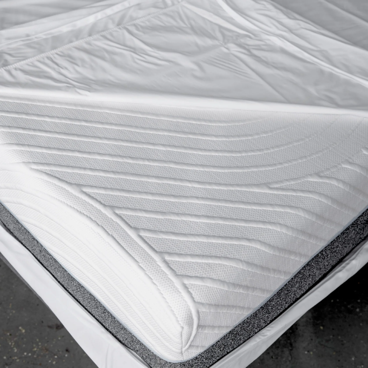 Close-up of a mattress showing Encased Protector with visible layers and texture
