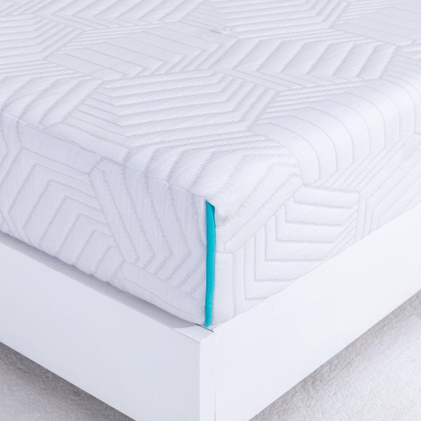 White 8 inch foam mattress in queen size with geometric pattern on a bed frame
