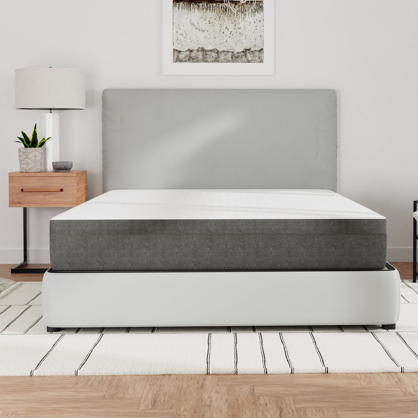 Modern bedroom with a bed / mattress, nightstand, lamp, and plant. Queen size mattress, top white and sides gray. Medium firmness
