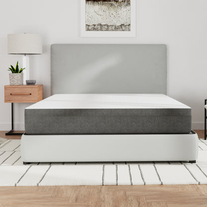 Modern bedroom with a bed / mattress, nightstand, lamp, and plant. Queen size mattress, top white and sides gray. Medium firmness
