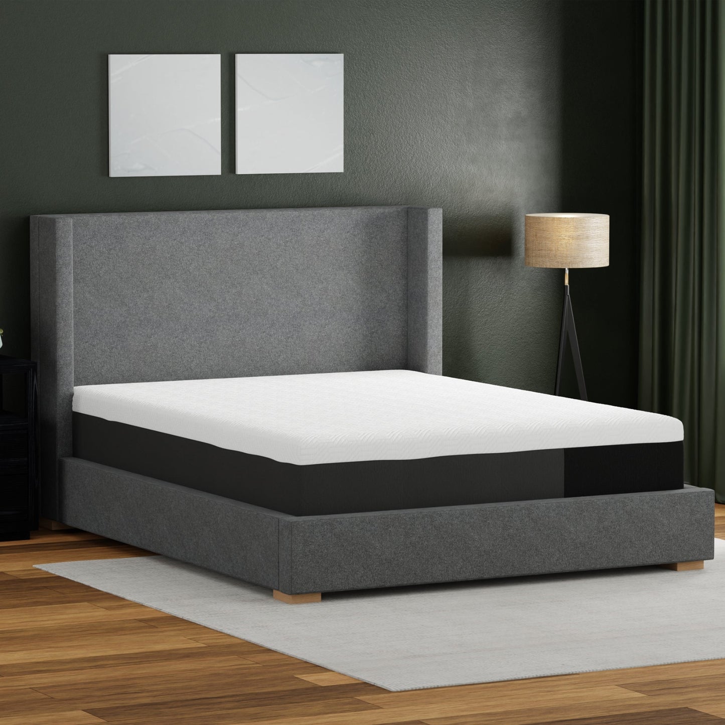 Gray upholstered bed with white mattress in a room with dark walls and a lamp.