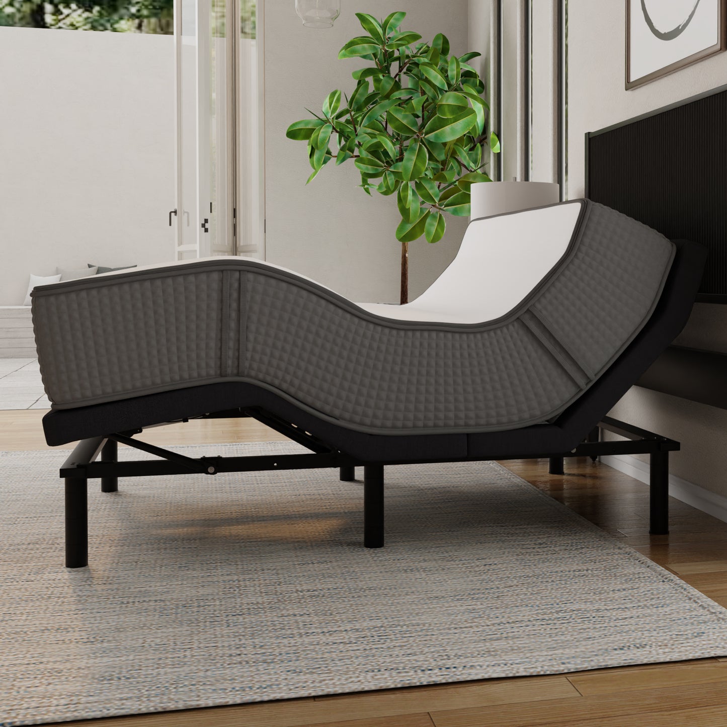 Modern bedroom with a bed / mattress on adjustable bed frame,nightstand, lamp, and plant. Queen size mattress, top white and sides gray. 2-sided mattress (one side firmer, one side softer)- flippable