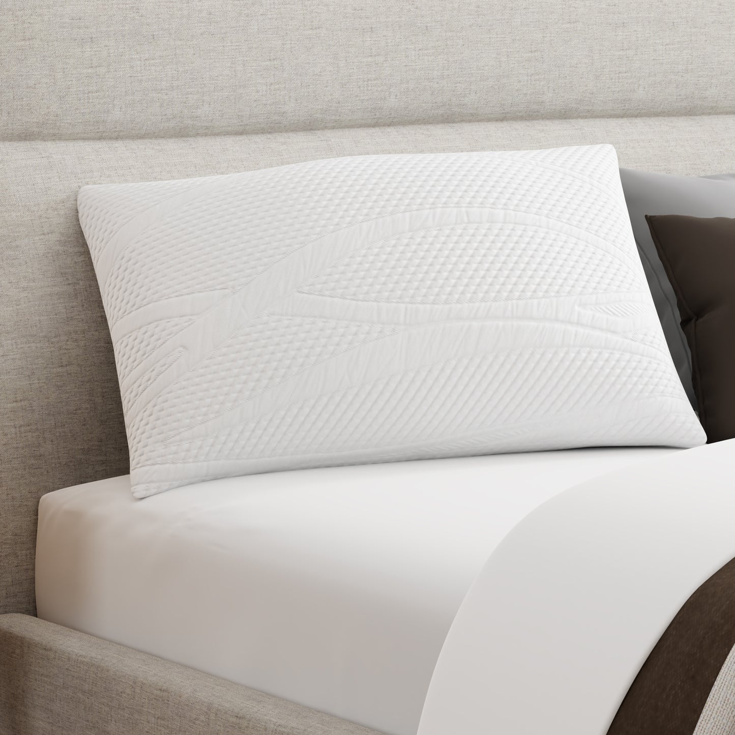 Owen Holmes Essentials Pillow resting on bed with soft white cover and modern stitching