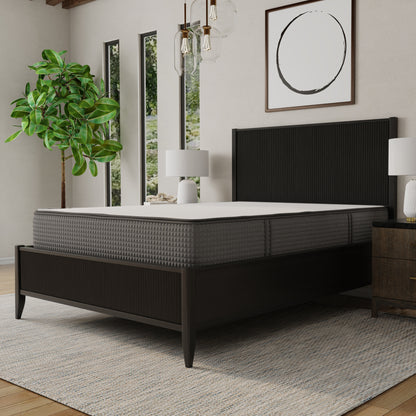 Modern bedroom with a bed / mattress, nightstand, lamp, and plant. Queen size mattress, top white and sides gray. 2-sided mattress (one side firmer, one side softer)- flippable