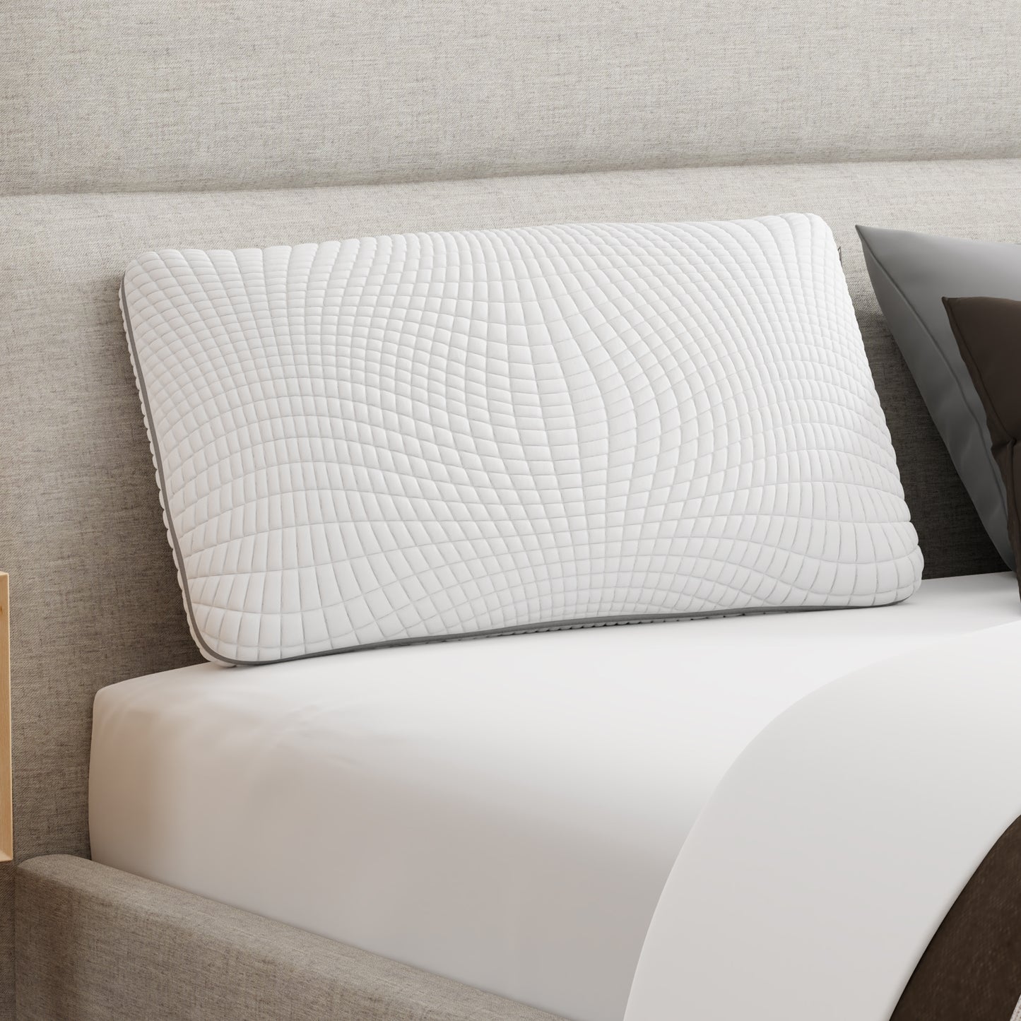 White pillow with a dark gray zipper. Bamboo Charcoal infused Pillow leaning on an upholstered headboard