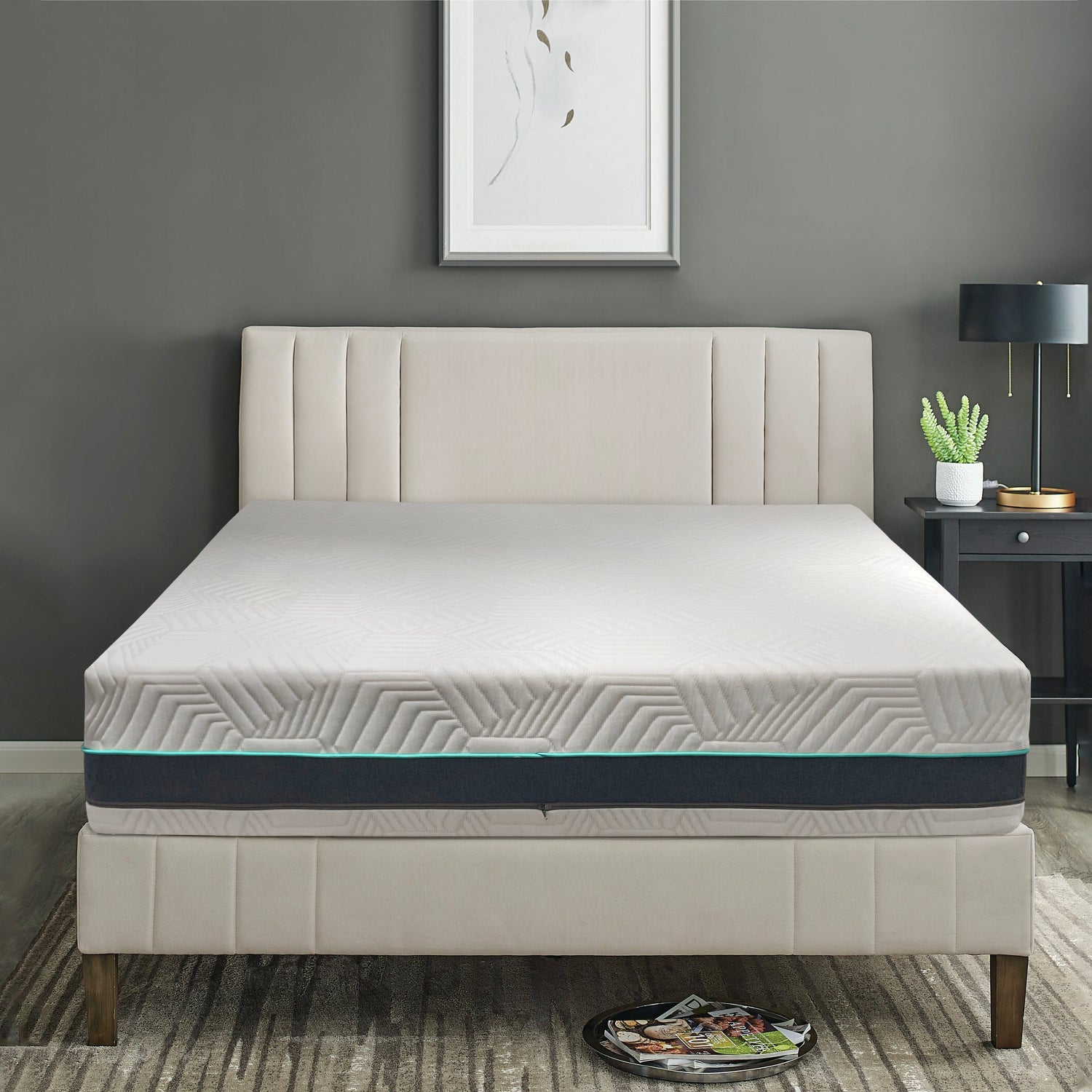 12 inch foam Mattress on a bed in a room with a gray wall and a nightstand with a lamp.