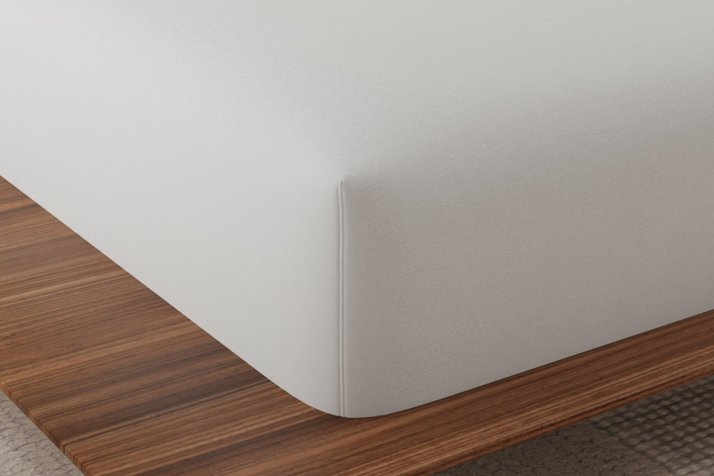 Corner shot of the Essentials mattress protector on a queen size mattress