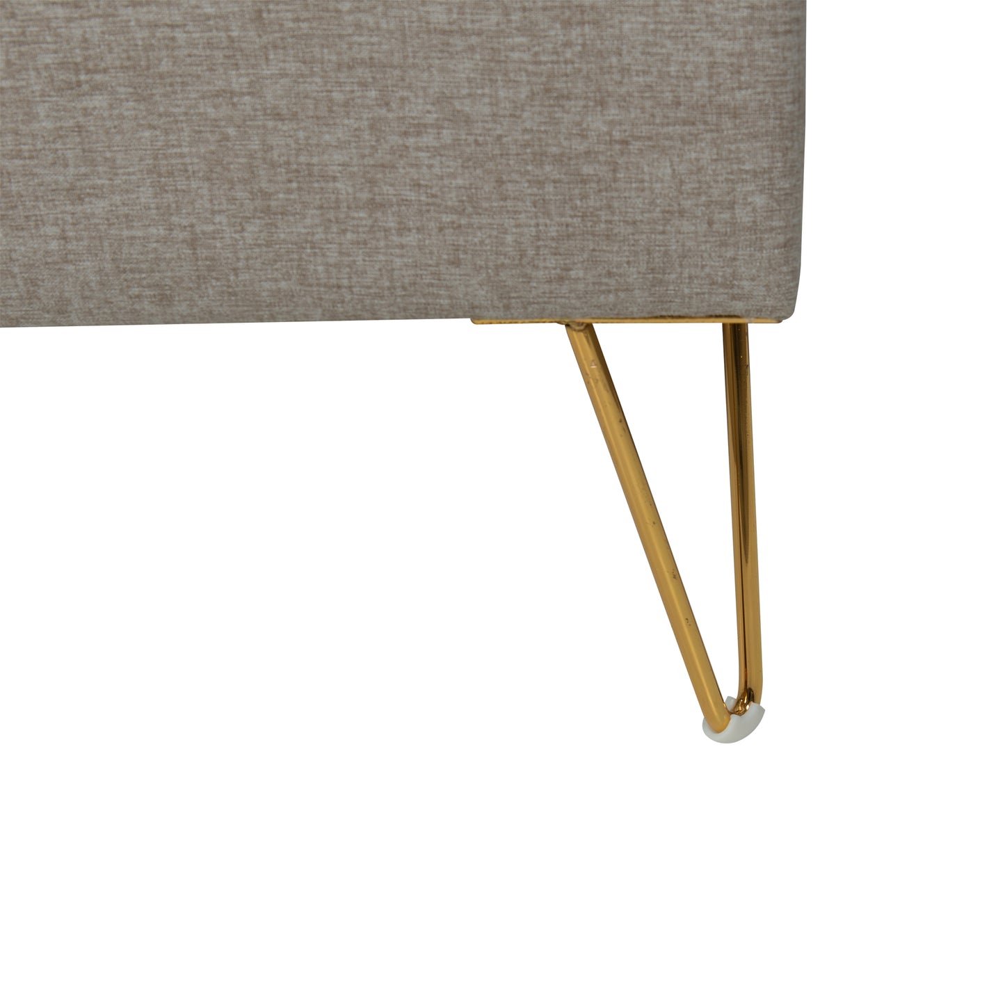 Close-up of a gray upholstered bed with brass metal legs on a white background