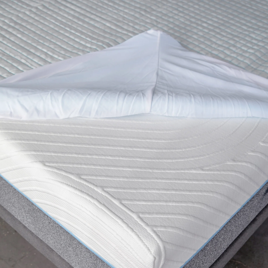Close-up of a mattress protector on a bed/mattress. shows underside cooling element.
