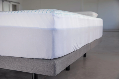 Ice Fiber mattress Protector on a mattress. image is a corner shot