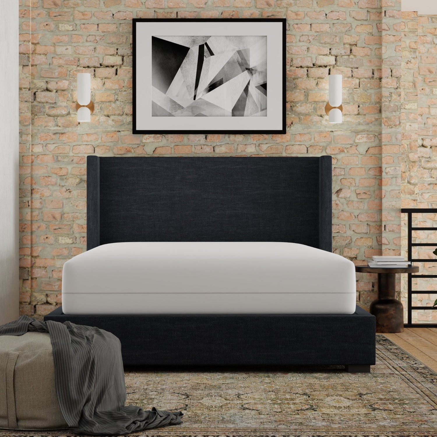 Modern bedroom with a black upholstered bed against a brick wall. Mattress has Igloo-Mattress_encasement_protector