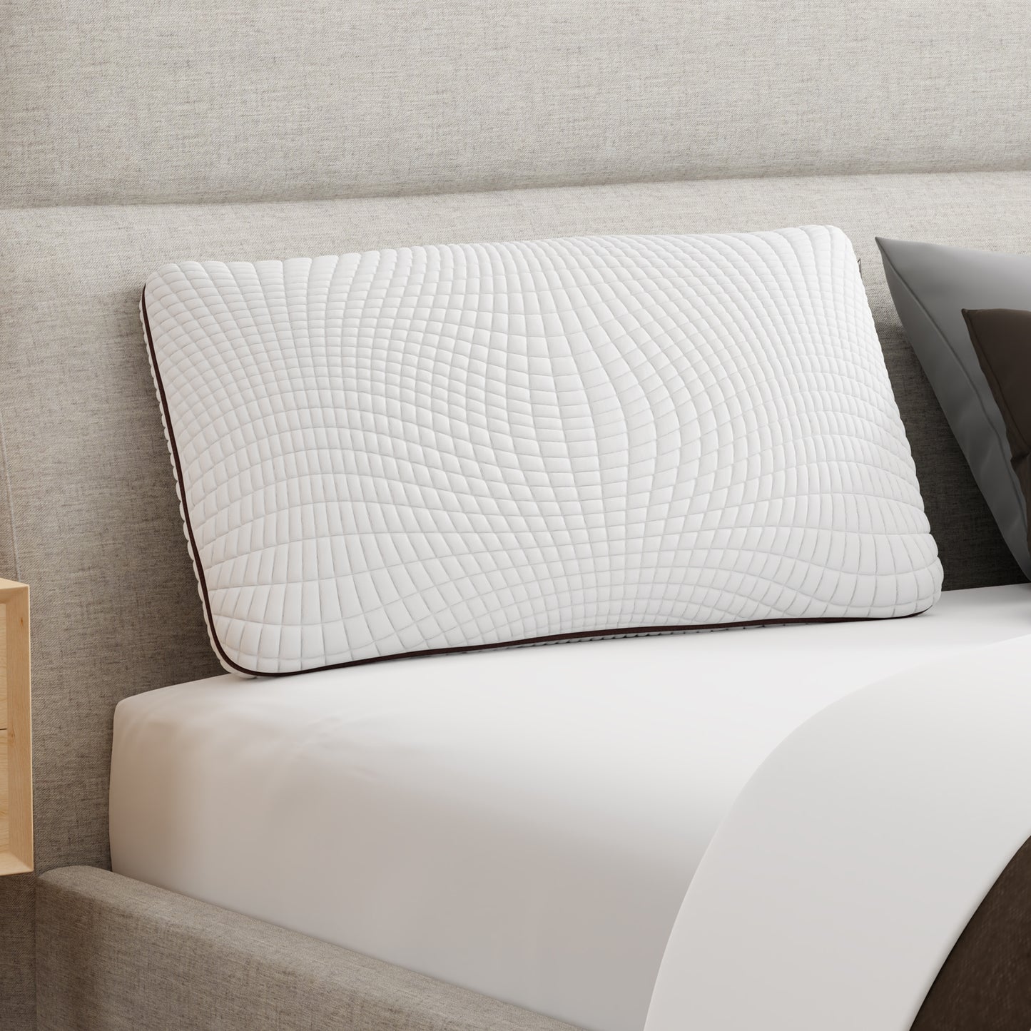 Memory foam Copper infused pillow on a mattress leaning against and upholstered headboard