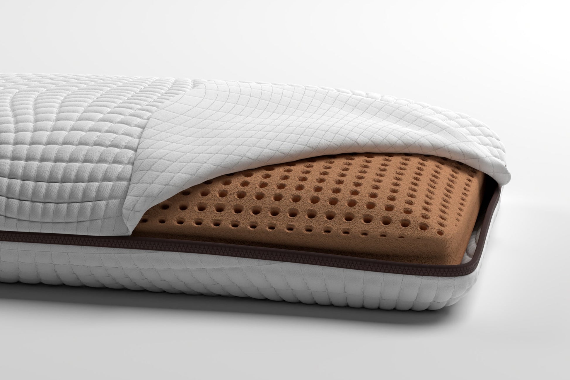 Close-up of a memory gel foam copper infused pillow on a white background. Pillow cover is lifted to show memory foam pillow underneath.