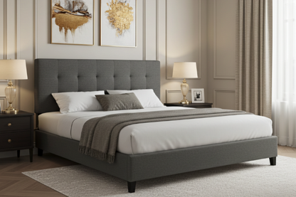 Gray upholstered bed with tufted headboard in a bedroom setting with lamps and artwork on the wall. Queen size bed/Mattress. white sheets
