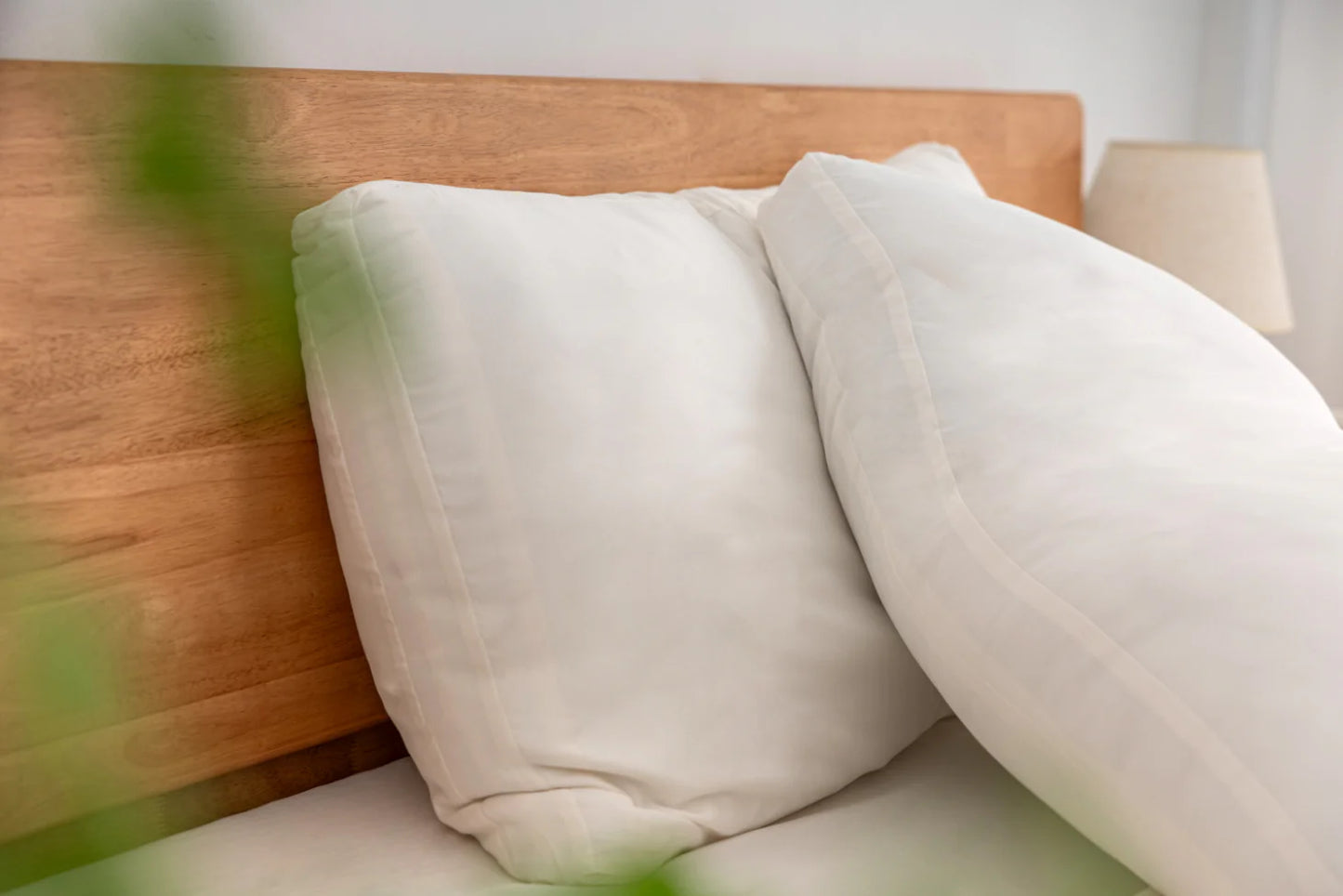 Set of soft washed down alternative pillows on a bed, showing plush shape and cozy sleep-ready comfort.