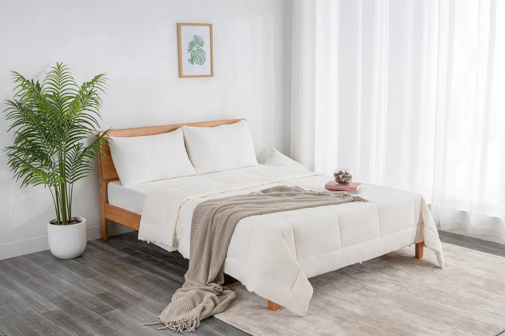 Soft washed pillow displayed on a neatly styled bed in a bright modern bedroom, highlighting its soft, supportive design.