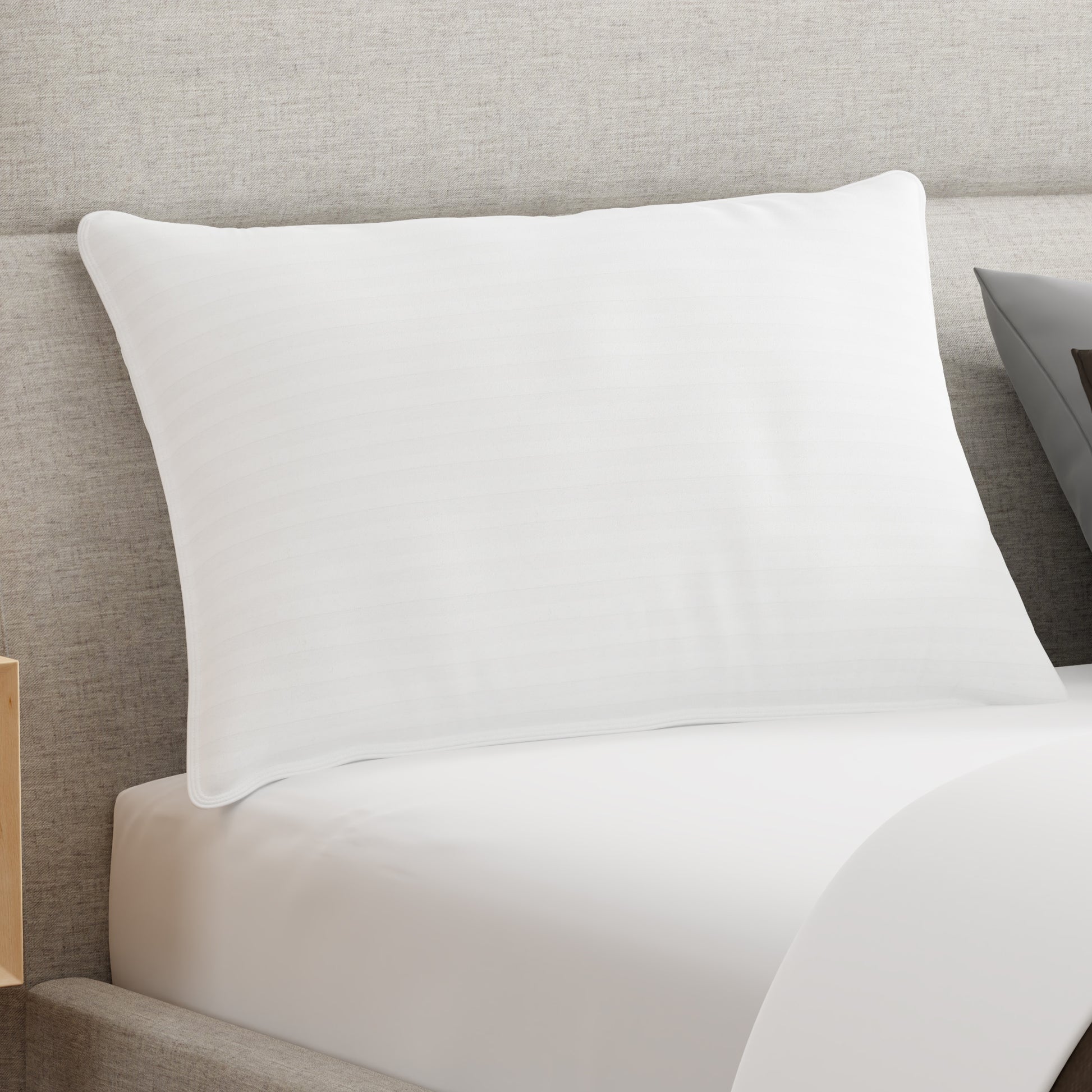 White pillow on a bed with a neutral headboard. Kapok foam fiber pillow