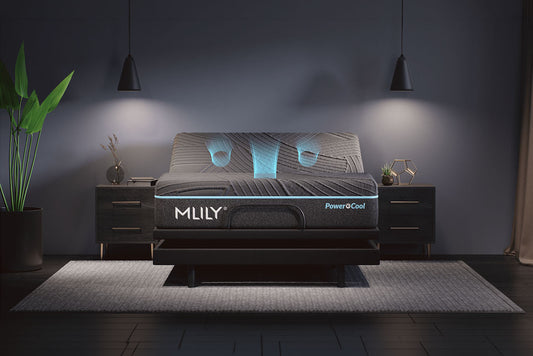 An Adjustable bed frame with a mattress shown in a styled bedroom scene. The bed frame is black with a glowing blue accent lines showing the built-in fan flow from the adjustable through the mattress. Brand name 'MLILY' is visible on the front.