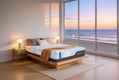 MLILY WellFlex Ice 3.0 cooling mattress on a wooden platform bed in a modern oceanfront bedroom at sunset